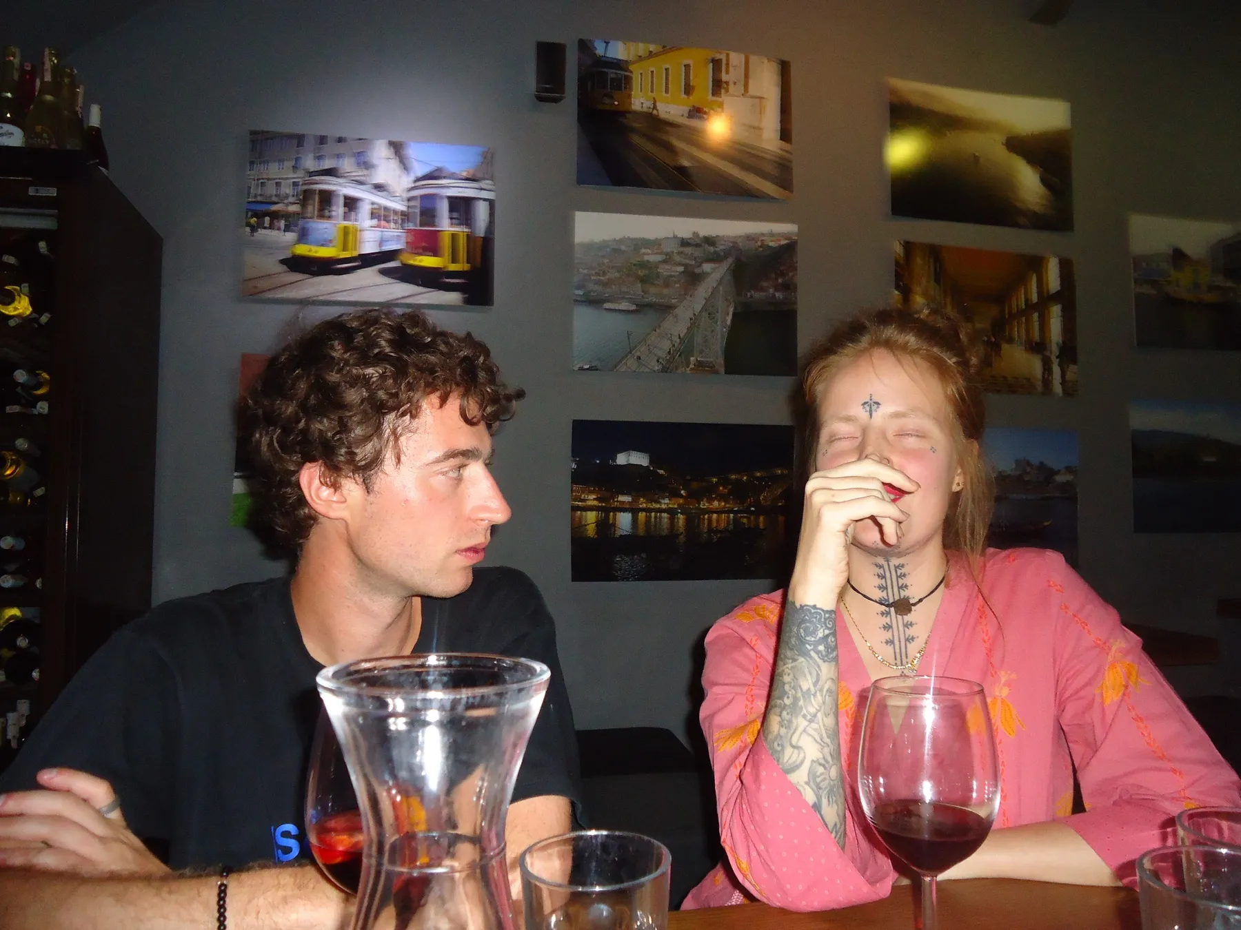 Man and woman at a table with glasses of red wine
