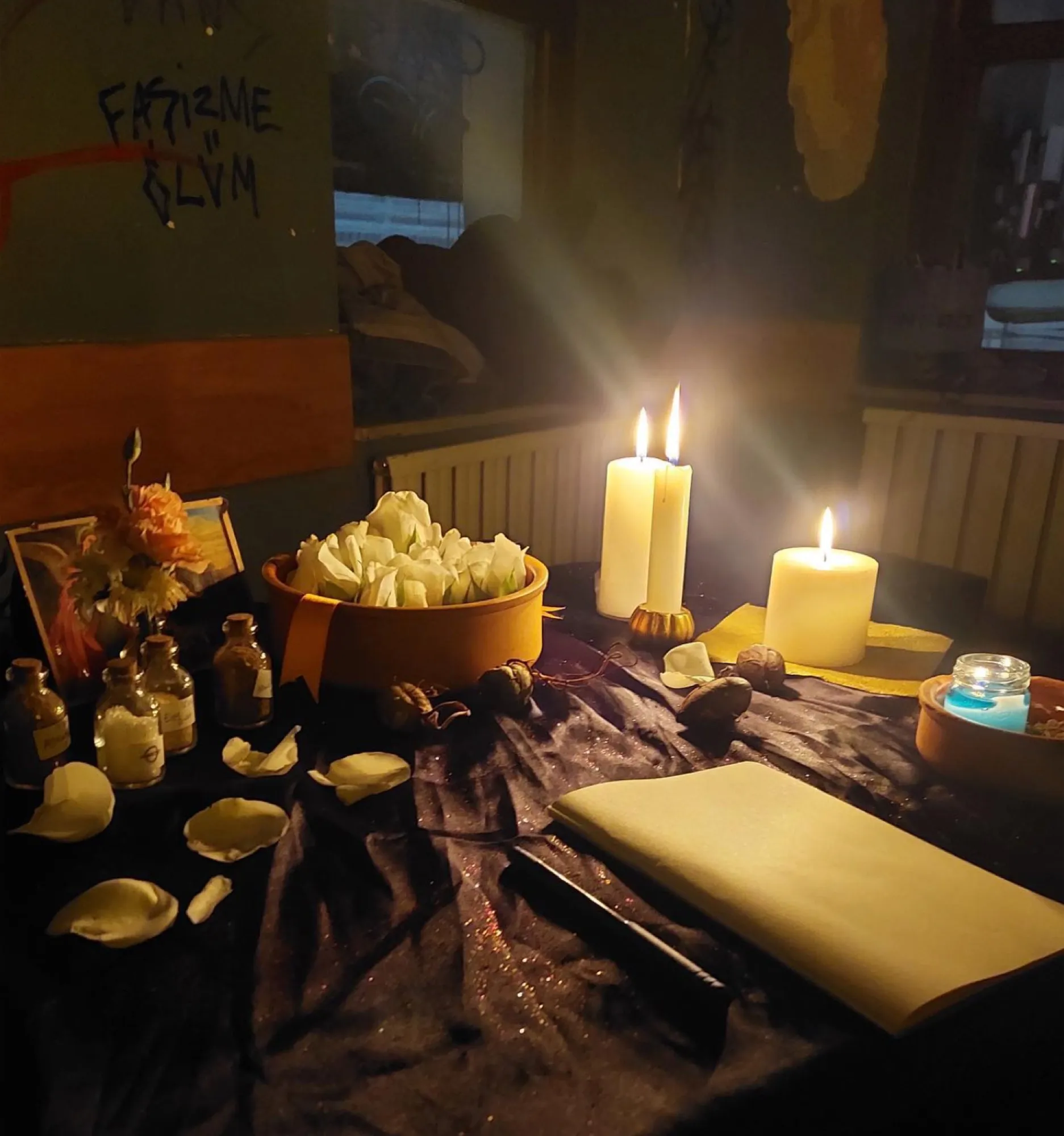 Table with candles, shells, flowers and small bottles in Akrep Tezgâhı