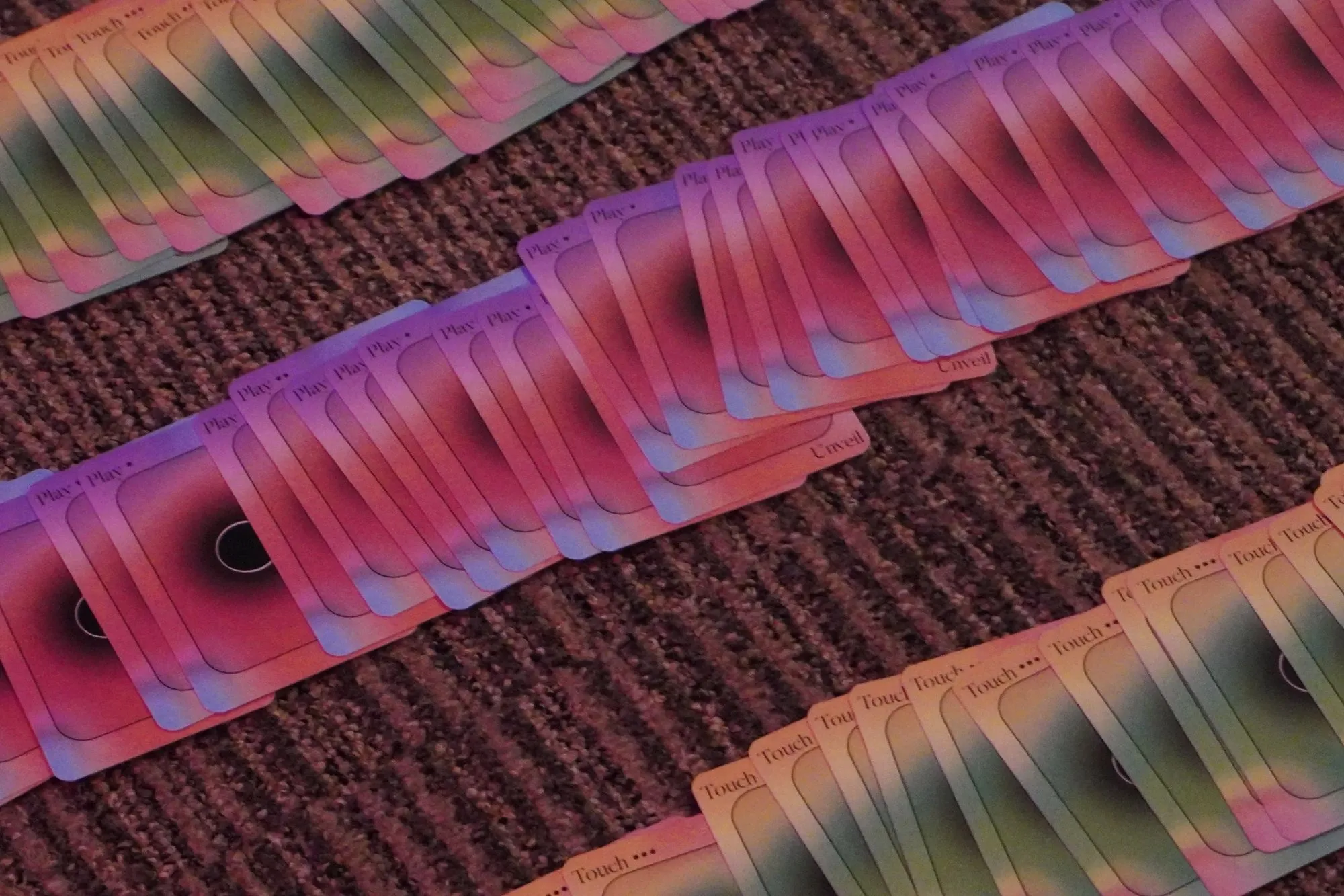 Rows of Play and Touch cards laid out on a carpet